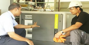 An engineer an a Leeds inspector examining an Atlas Copco air compressor