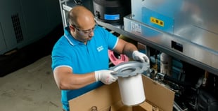 Image of an engineer replacing a filter