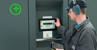 Image of an engineer inspecting an air compressor