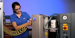 Image of an engineer working on an Atlas Copco compressor