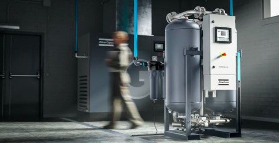 Image of a person walking past a desiccant air dryer