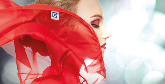 Side profile image of a woman with a red veil slightly covering her face