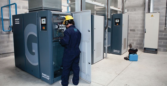 Image of an Atlas Copco engineer working on a compressor