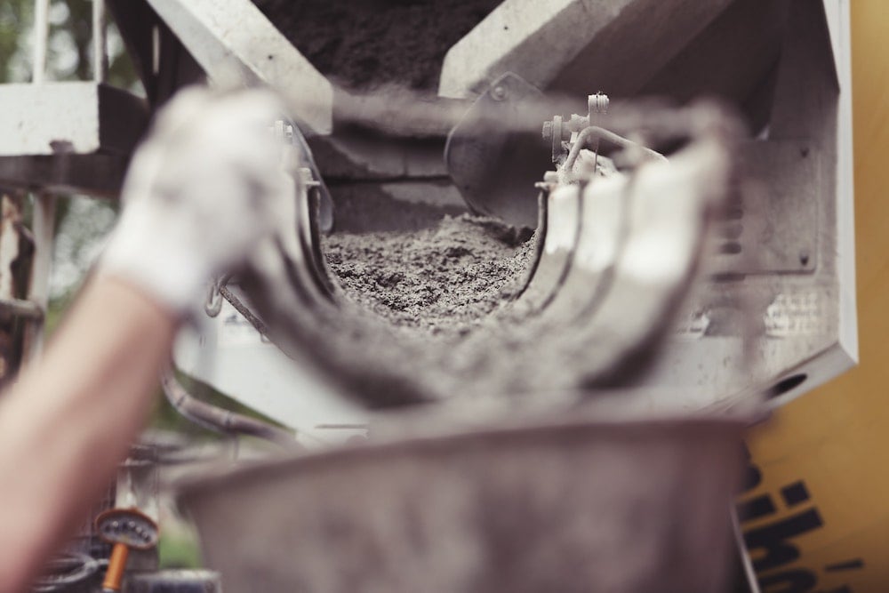 Image of cement being poured into a bucket